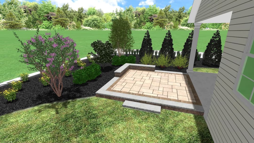Patio area with landscaping, featuring bushes, flowers, and a grassy lawn in a garden setting.